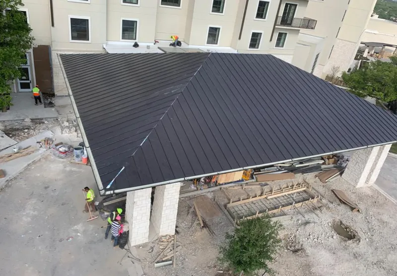 Metal roofing installation team working on a commercial building in Riverview